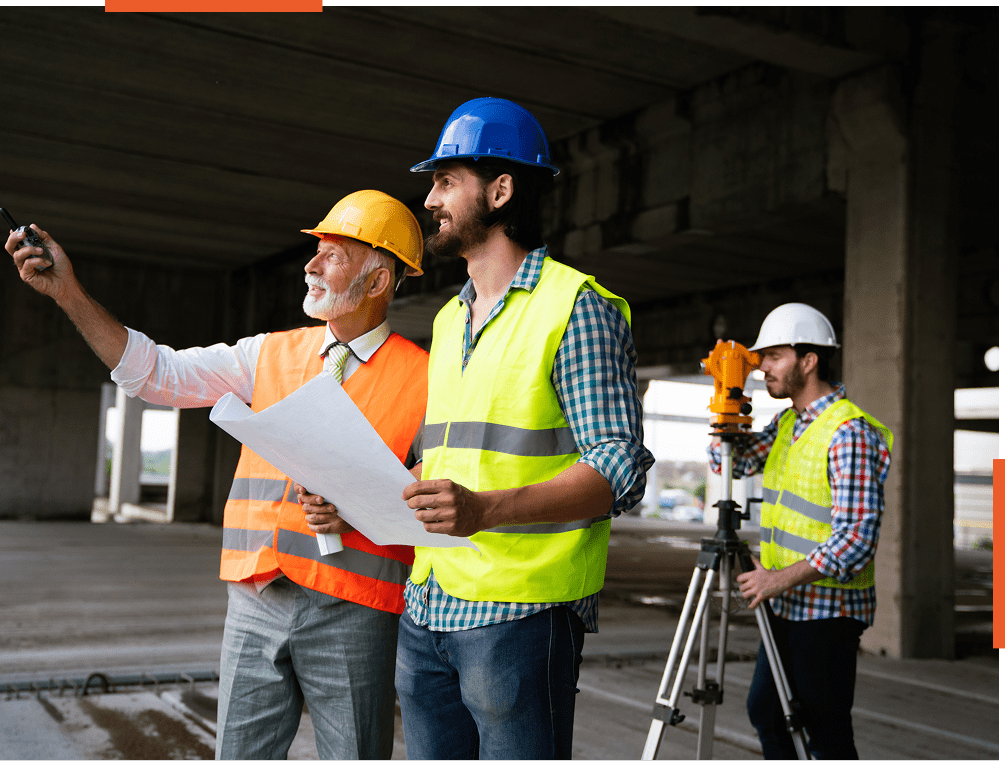 Construction workers reviewing plans on site.