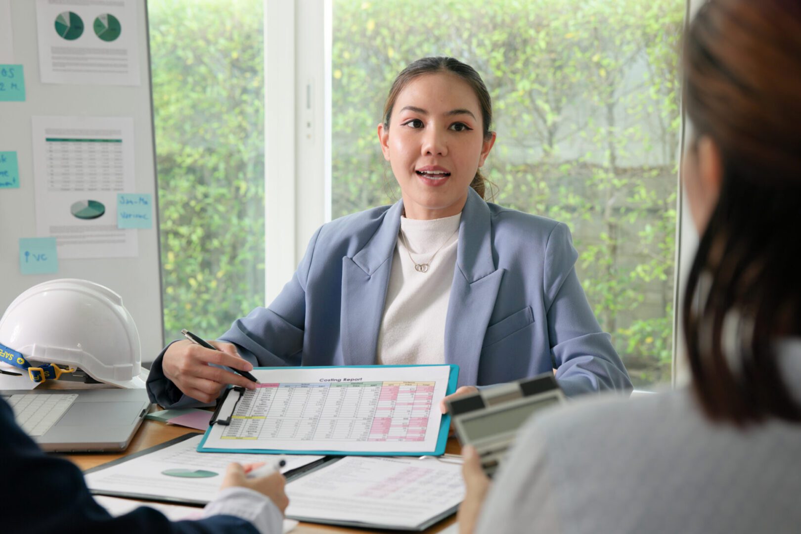 Woman presenting charts in a business meeting.