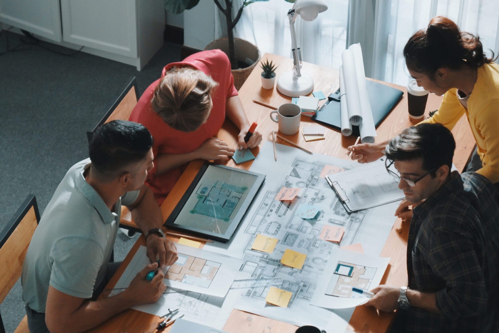 Group collaborating on architectural design plans.